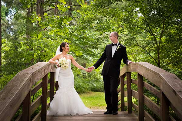 bride and groom on an bridge